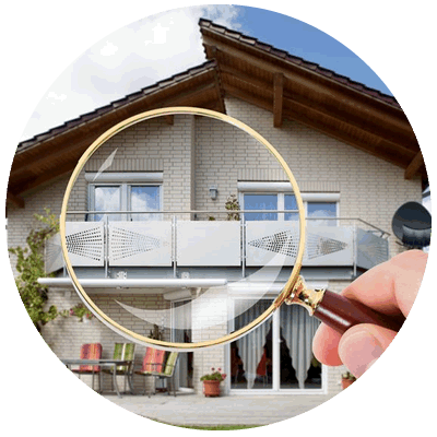Hand holding a magnifying glass inspecting a two story home in Florida, USA